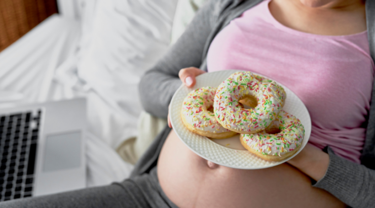 pregnnacy nutrition - pregnant woman about to eat donuts